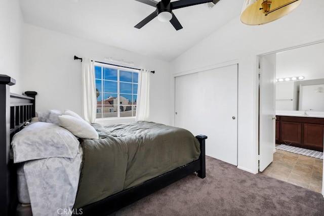 bedroom featuring ensuite bathroom, light colored carpet, ceiling fan, a closet, and lofted ceiling