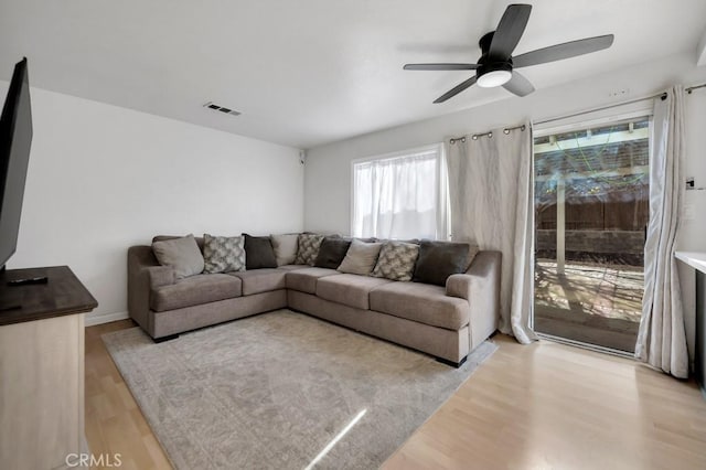 living room with light wood-type flooring and ceiling fan