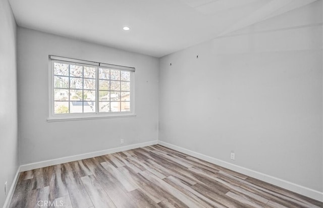 spare room with light hardwood / wood-style flooring