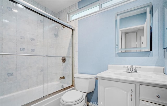 full bathroom featuring shower / bath combination with glass door, vanity, and toilet