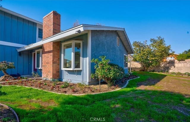 view of property exterior with a lawn