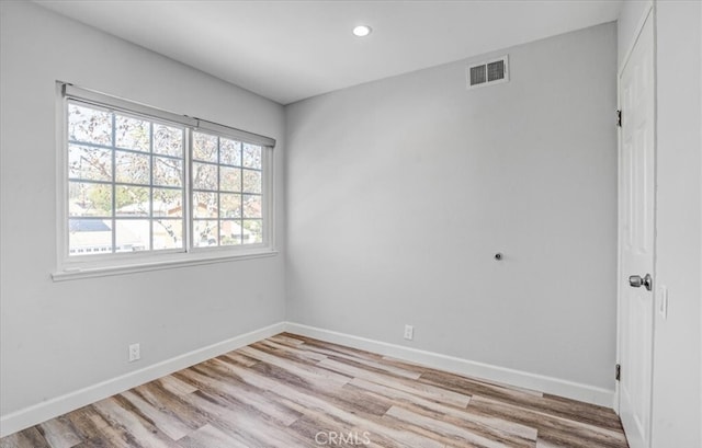 empty room with light hardwood / wood-style flooring