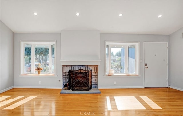 unfurnished living room featuring a fireplace and light hardwood / wood-style flooring