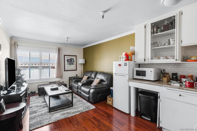 living room featuring dark hardwood / wood-style flooring and crown molding