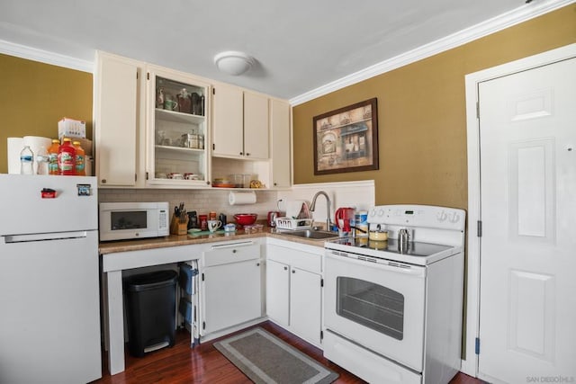 kitchen with decorative backsplash, white appliances, dark wood-type flooring, sink, and white cabinetry