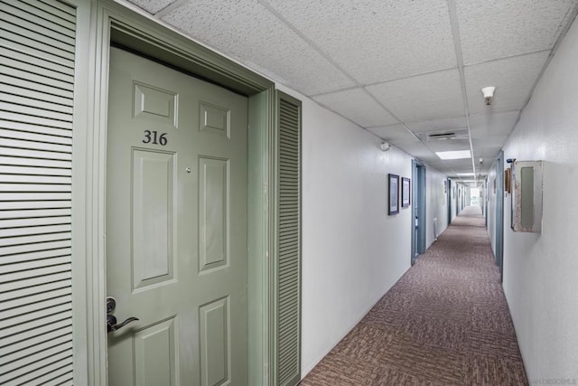 corridor featuring a paneled ceiling