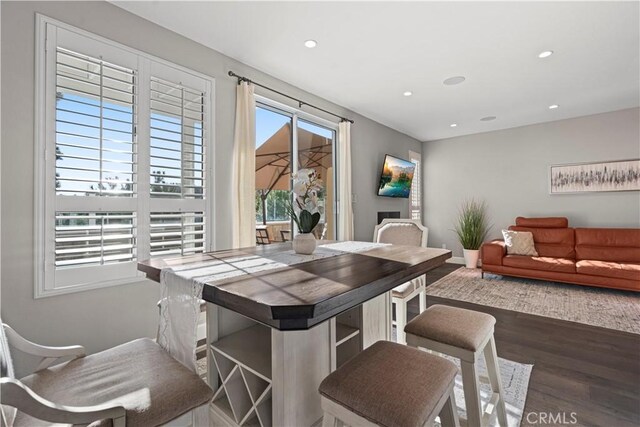 dining space with dark hardwood / wood-style flooring