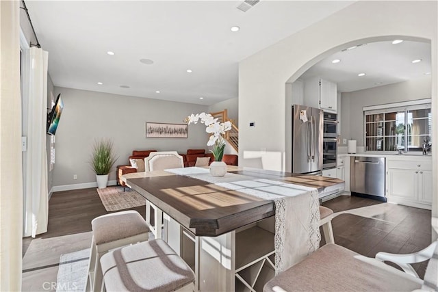 dining area with dark hardwood / wood-style flooring and sink