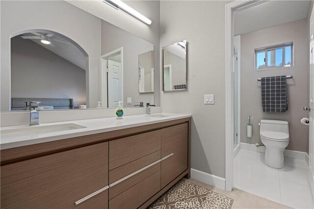 bathroom with tile patterned floors, ceiling fan, vanity, and toilet