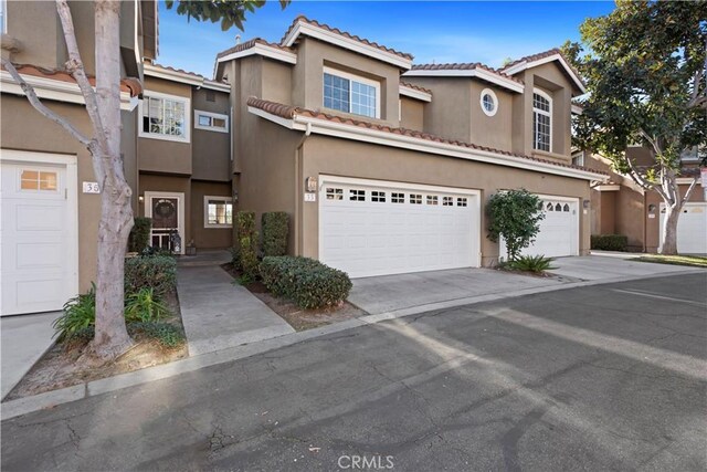 townhome / multi-family property featuring a garage