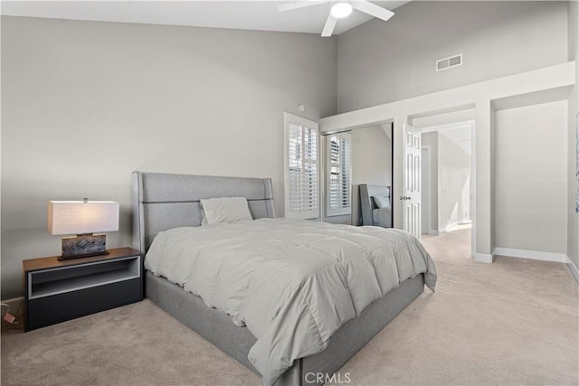 carpeted bedroom featuring ceiling fan and a closet