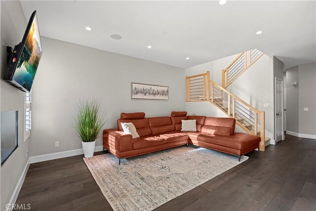 living room with dark hardwood / wood-style flooring