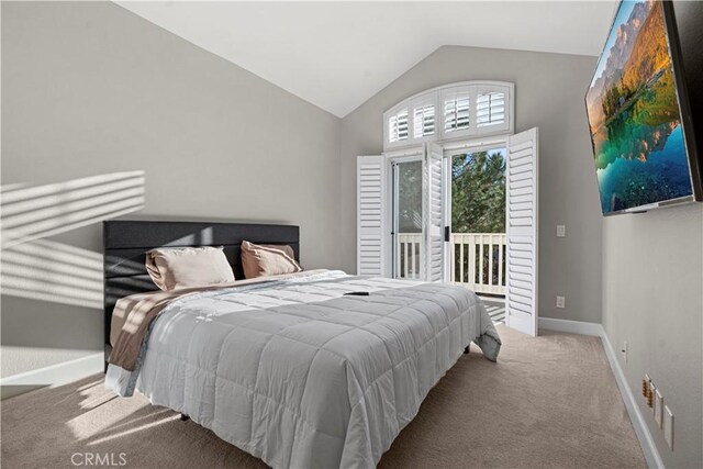 bedroom with access to outside, light colored carpet, and lofted ceiling