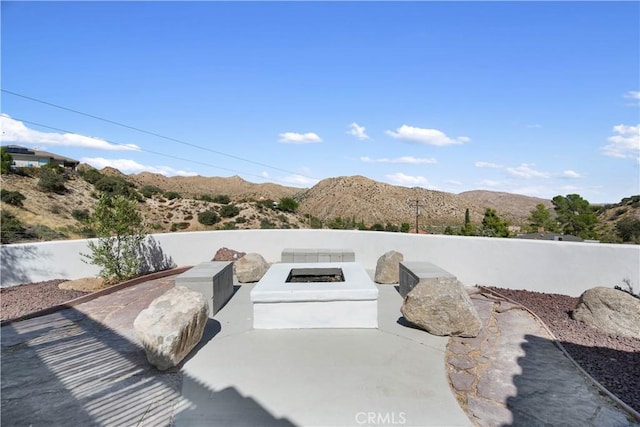 details featuring a mountain view and an outdoor fire pit