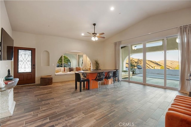 dining area with a mountain view, vaulted ceiling, and ceiling fan