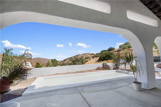 view of patio / terrace featuring a mountain view