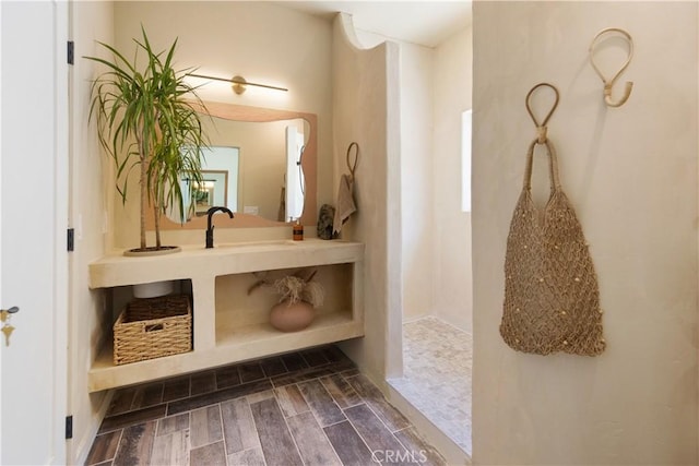 interior space with vanity and walk in shower