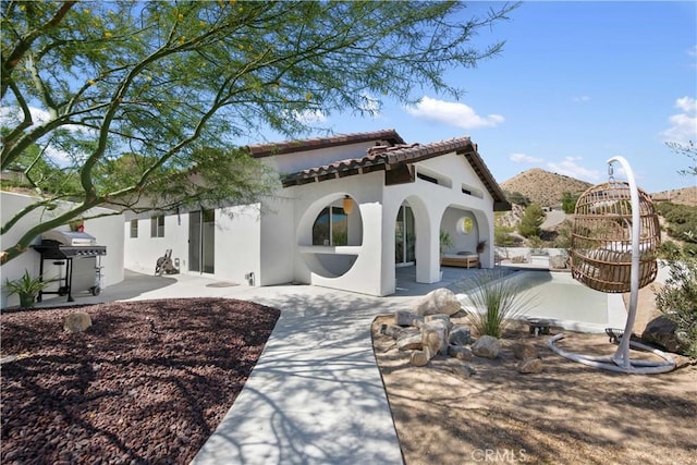 exterior space with a mountain view and a patio