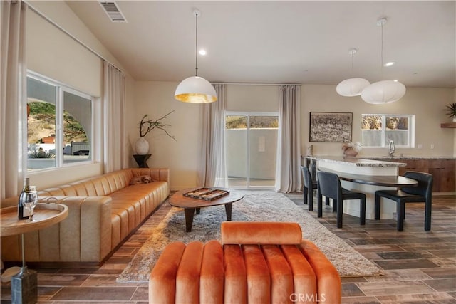 living room with a wealth of natural light and sink