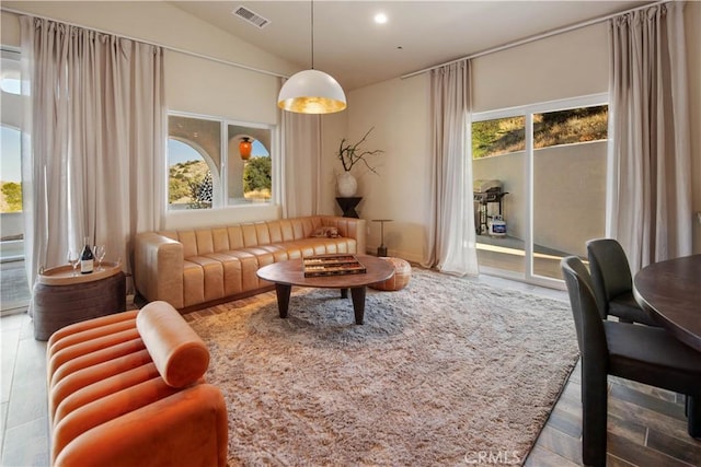 living area with plenty of natural light and lofted ceiling