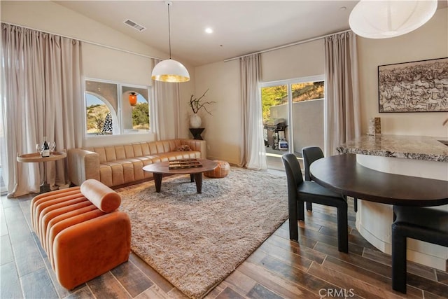 living area featuring plenty of natural light and vaulted ceiling