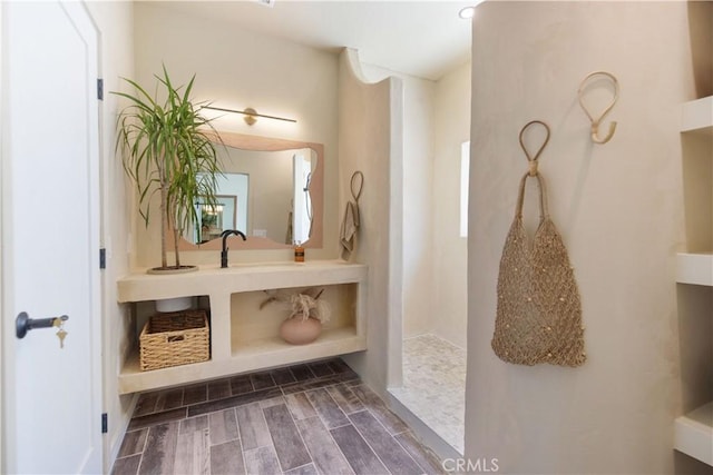 bathroom featuring a shower and vanity