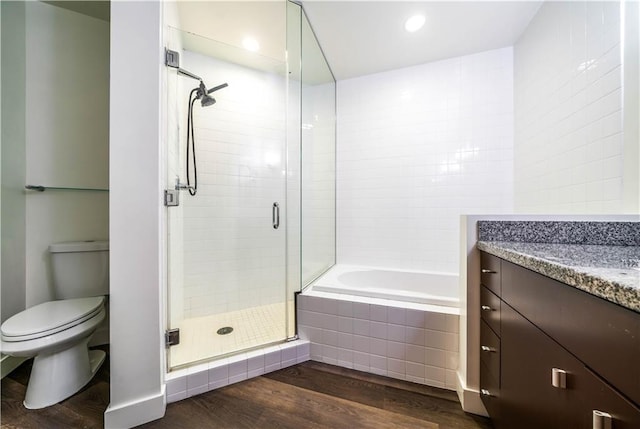 1100 Wilshire Blvd Unit 2707, Los Angeles, CA 90017 - full bathroom featuring vanity, toilet, wood-type flooring, and independent shower and bath