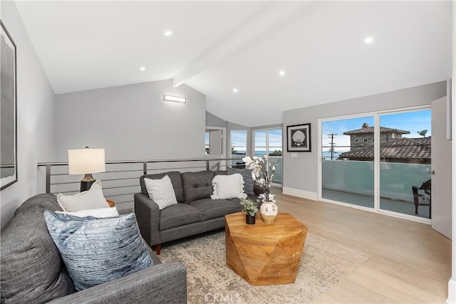 living room featuring light hardwood / wood-style floors and vaulted ceiling with beams