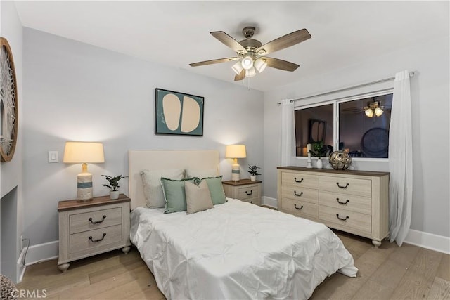 bedroom with light hardwood / wood-style floors and ceiling fan