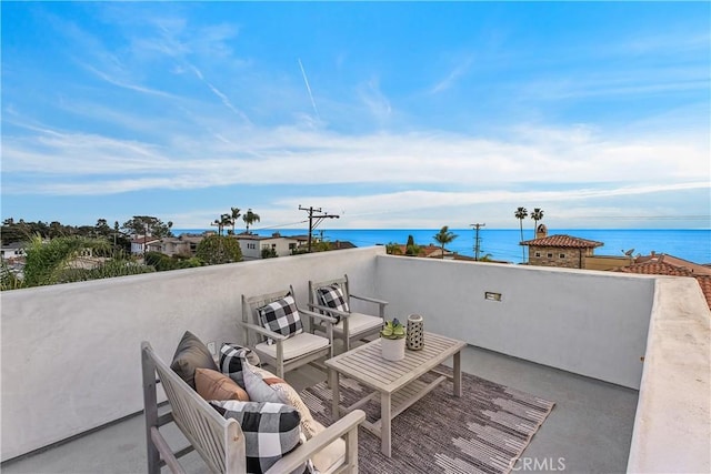 view of patio with a balcony and a water view