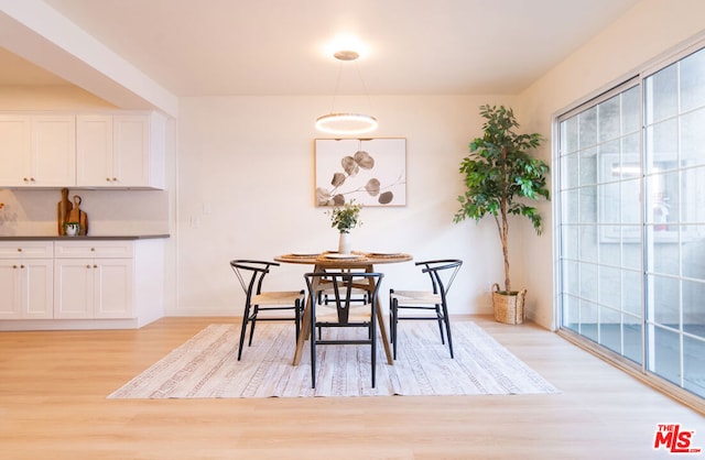 dining space featuring light wood-type flooring and a wealth of natural light