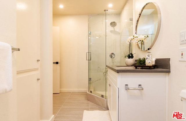 bathroom with tile patterned floors and a shower with door