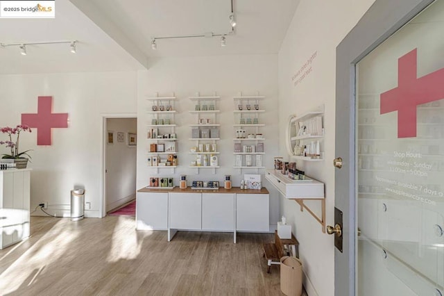 bathroom with hardwood / wood-style floors