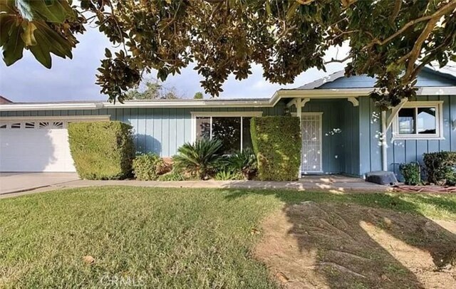 view of front of home featuring a garage and a front lawn