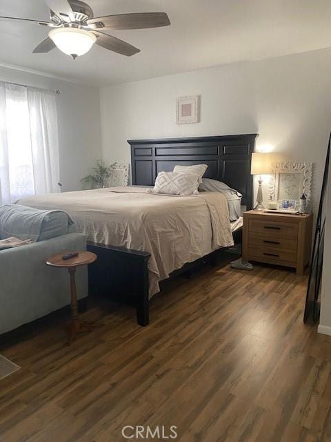 bedroom featuring ceiling fan and dark wood finished floors