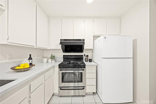 kitchen with white fridge, light tile patterned floors, gas stove, and white cabinets