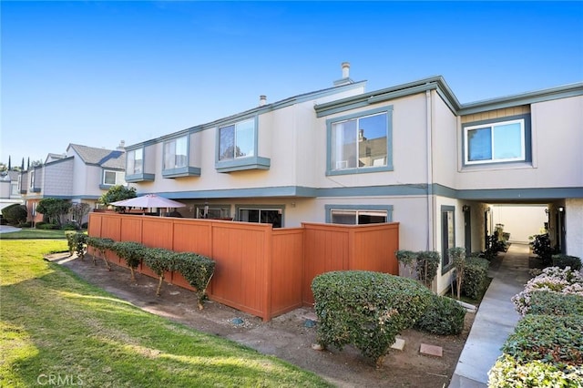 view of side of home with a lawn