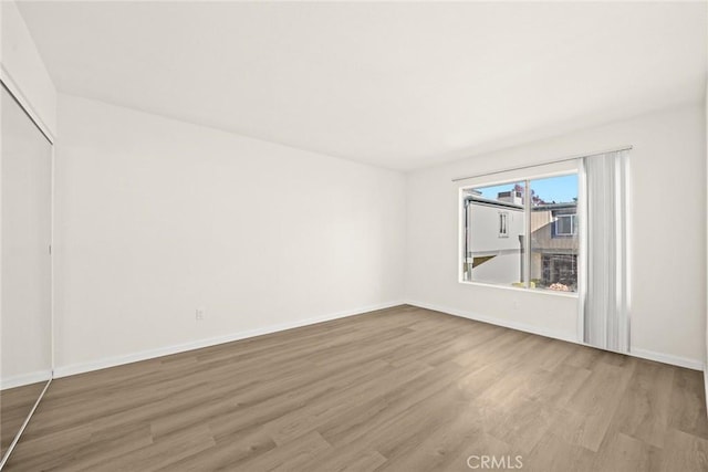 unfurnished room featuring hardwood / wood-style flooring