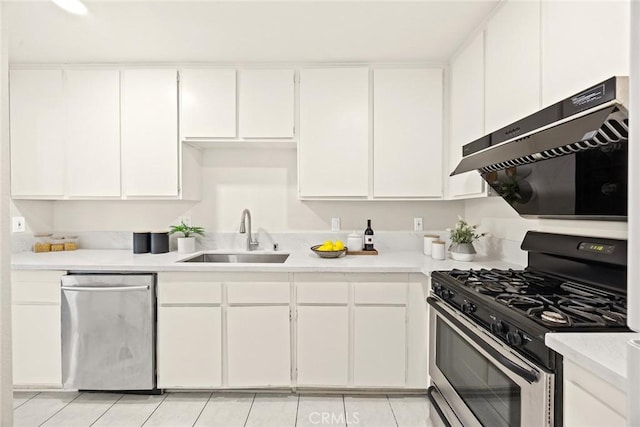 kitchen with light tile patterned floors, sink, white cabinetry, and appliances with stainless steel finishes