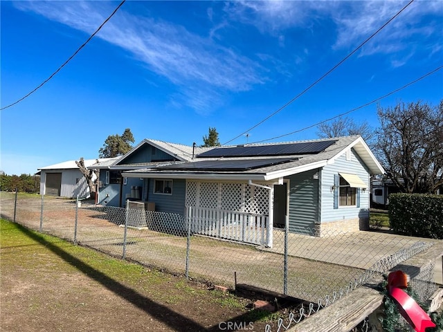 view of front of property with a garage and solar panels