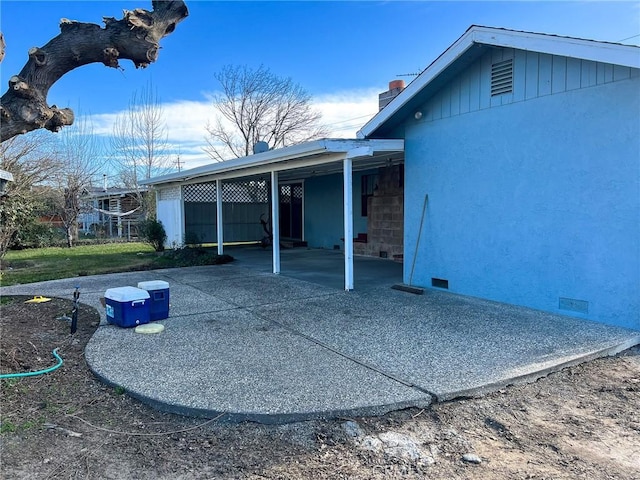 back of house with a carport