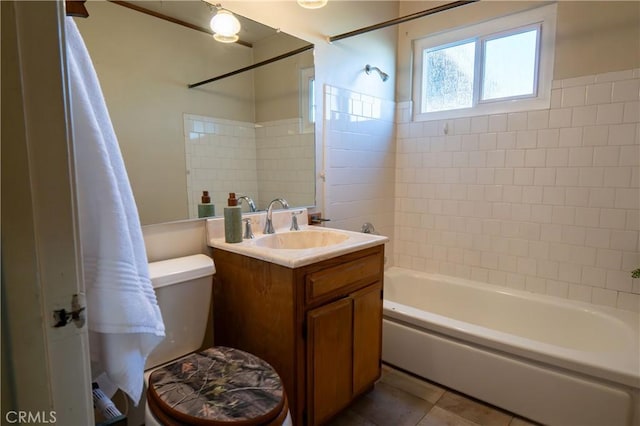 full bathroom with vanity, tiled shower / bath, tile patterned floors, and toilet