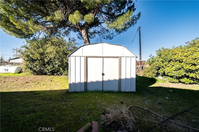 view of outbuilding featuring a yard