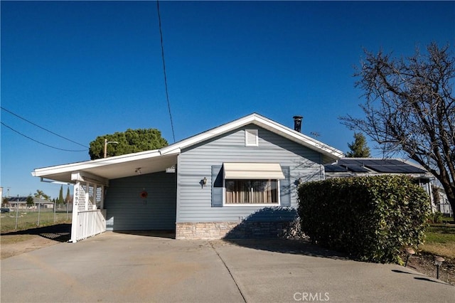 view of home's exterior featuring a carport