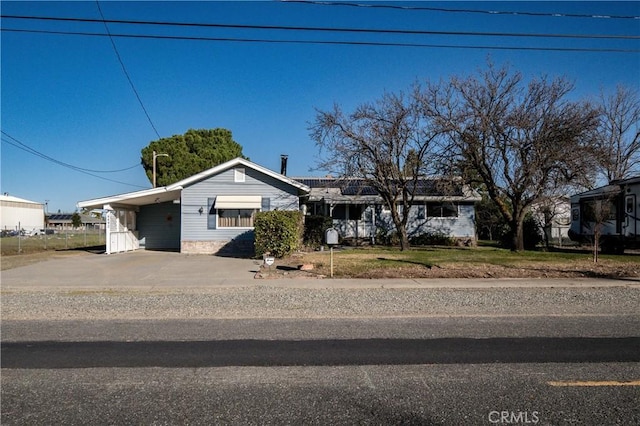 single story home featuring a carport