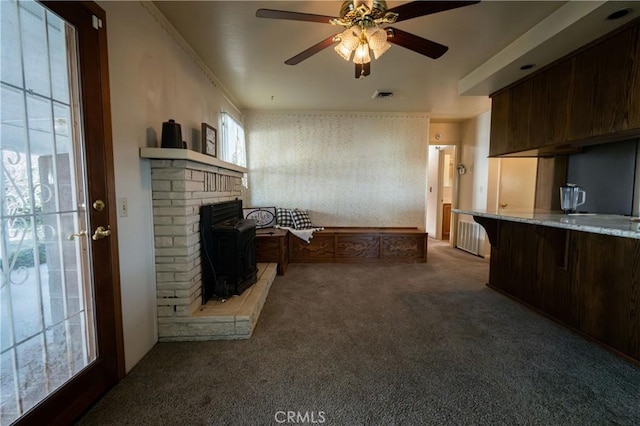 carpeted living room featuring ceiling fan