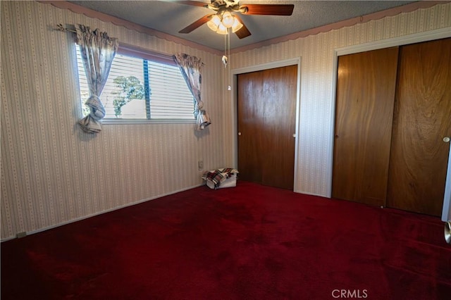 unfurnished bedroom with a textured ceiling and ceiling fan