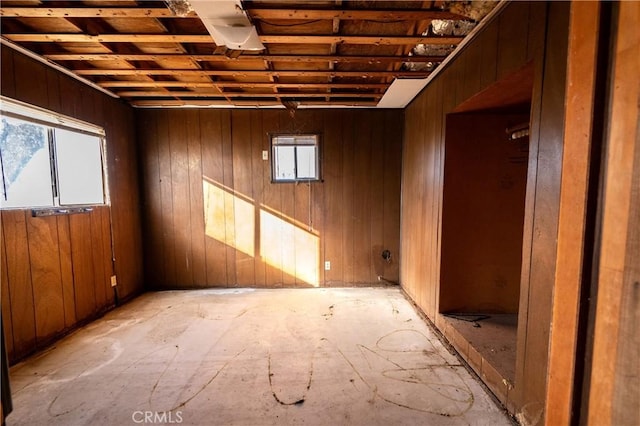 unfurnished room with wood walls