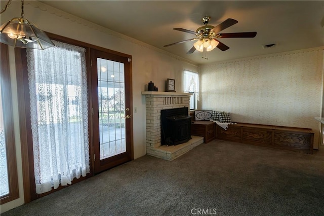 living room featuring ornamental molding, carpet floors, and ceiling fan