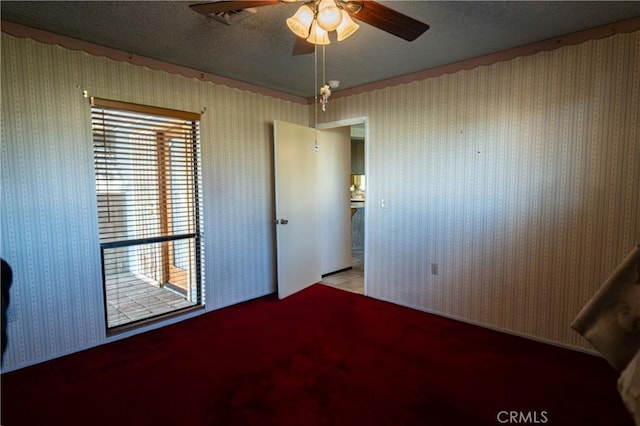 unfurnished bedroom with a textured ceiling and ceiling fan